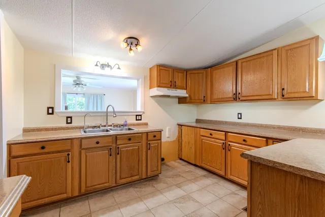 a kitchen with stainless steel appliances granite countertop a sink and cabinets