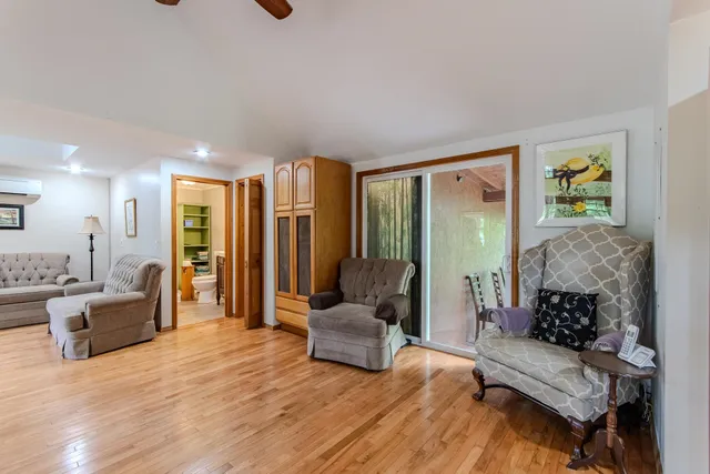 a living room with furniture and wooden floor