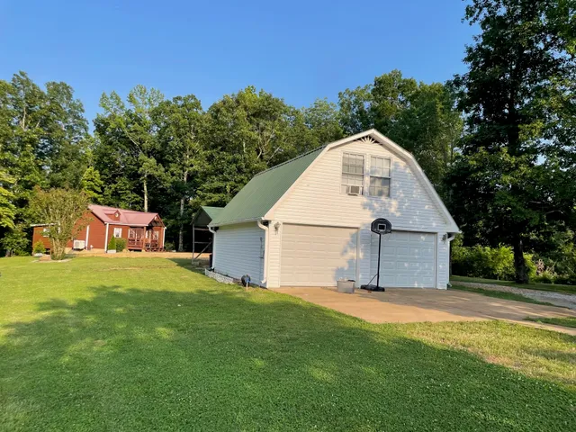 a view of an house with backyard space and garden