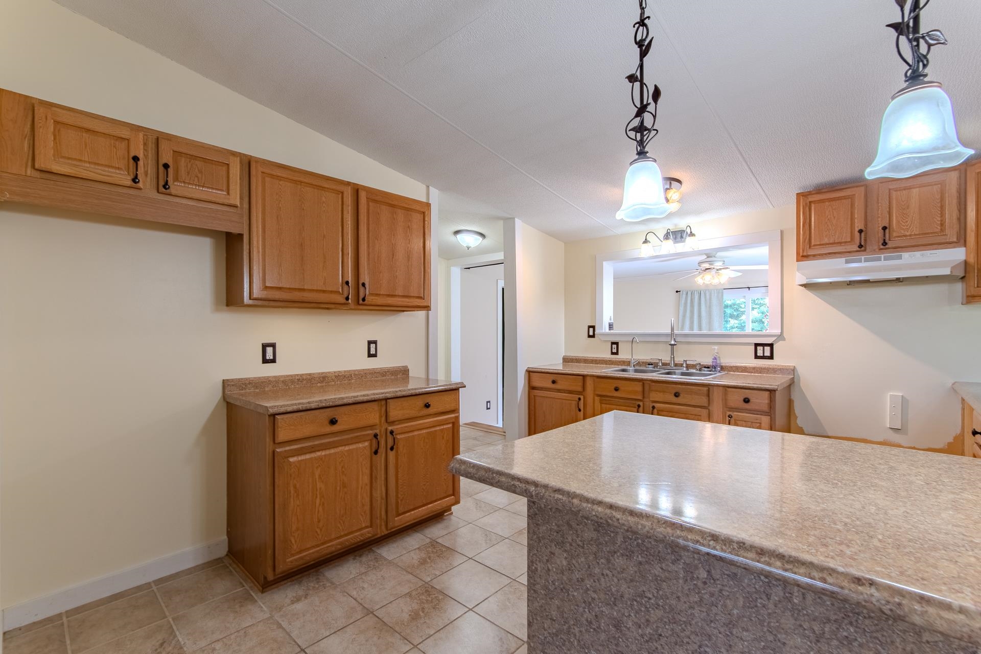 23 Old Ferry Road Bath Springs, TN 38311 - Photo 3 of 40 a kitchen with stainless steel appliances granite countertop a sink counter space cabinets and a stove