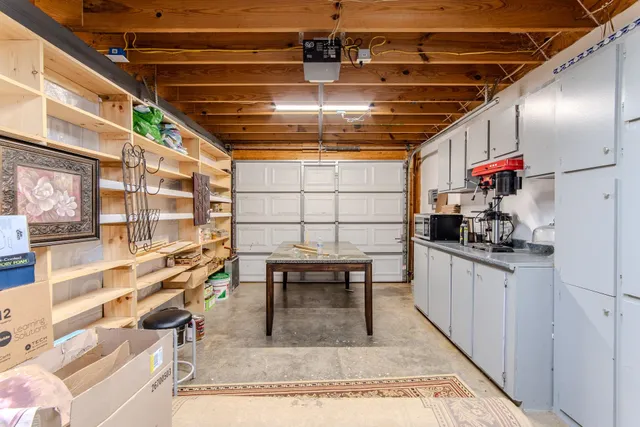 a kitchen with stainless steel appliances kitchen island granite countertop a sink and cabinets