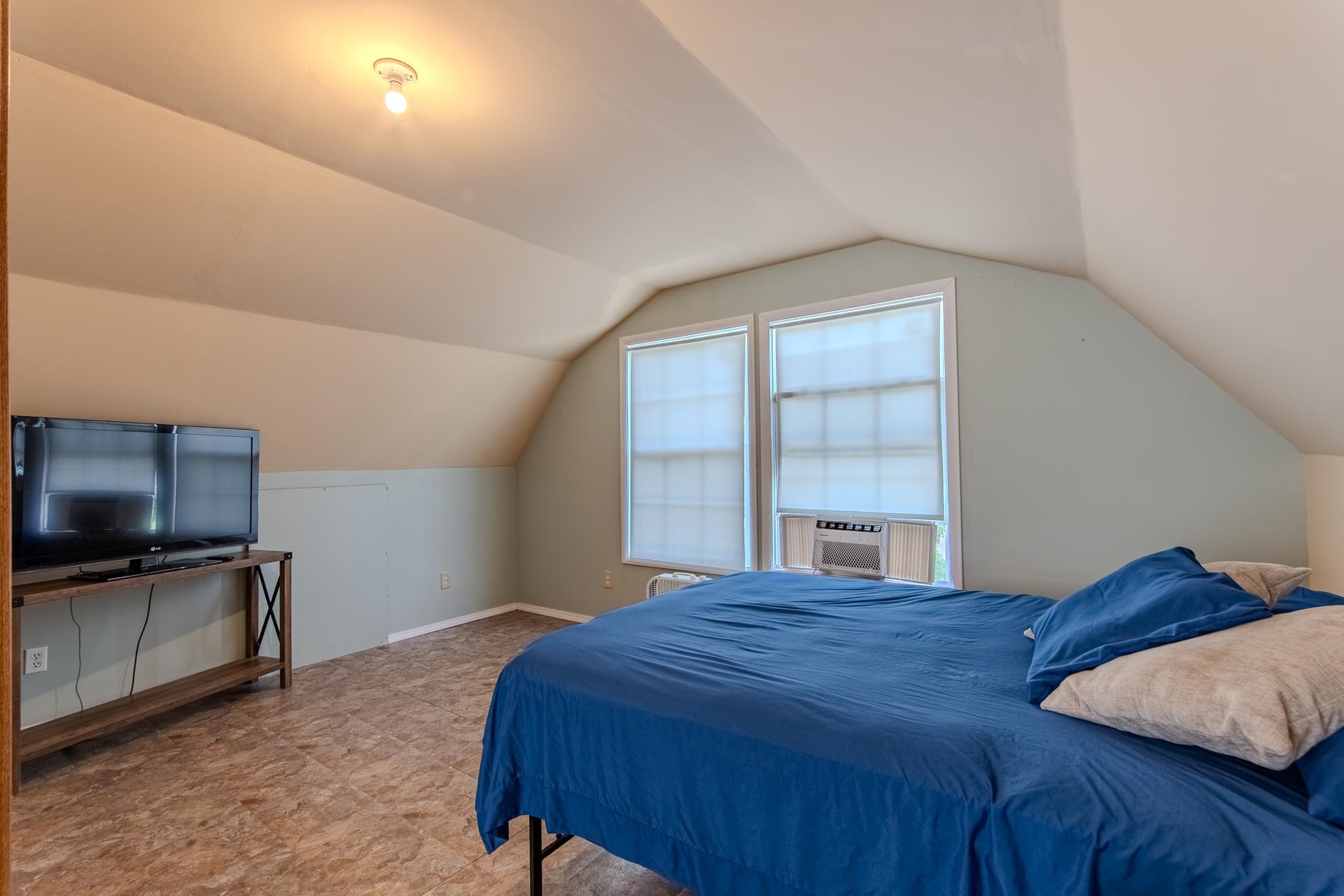 23 Old Ferry Road Bath Springs, TN 38311 - Photo 32 of 40 a bedroom with a bed and a television