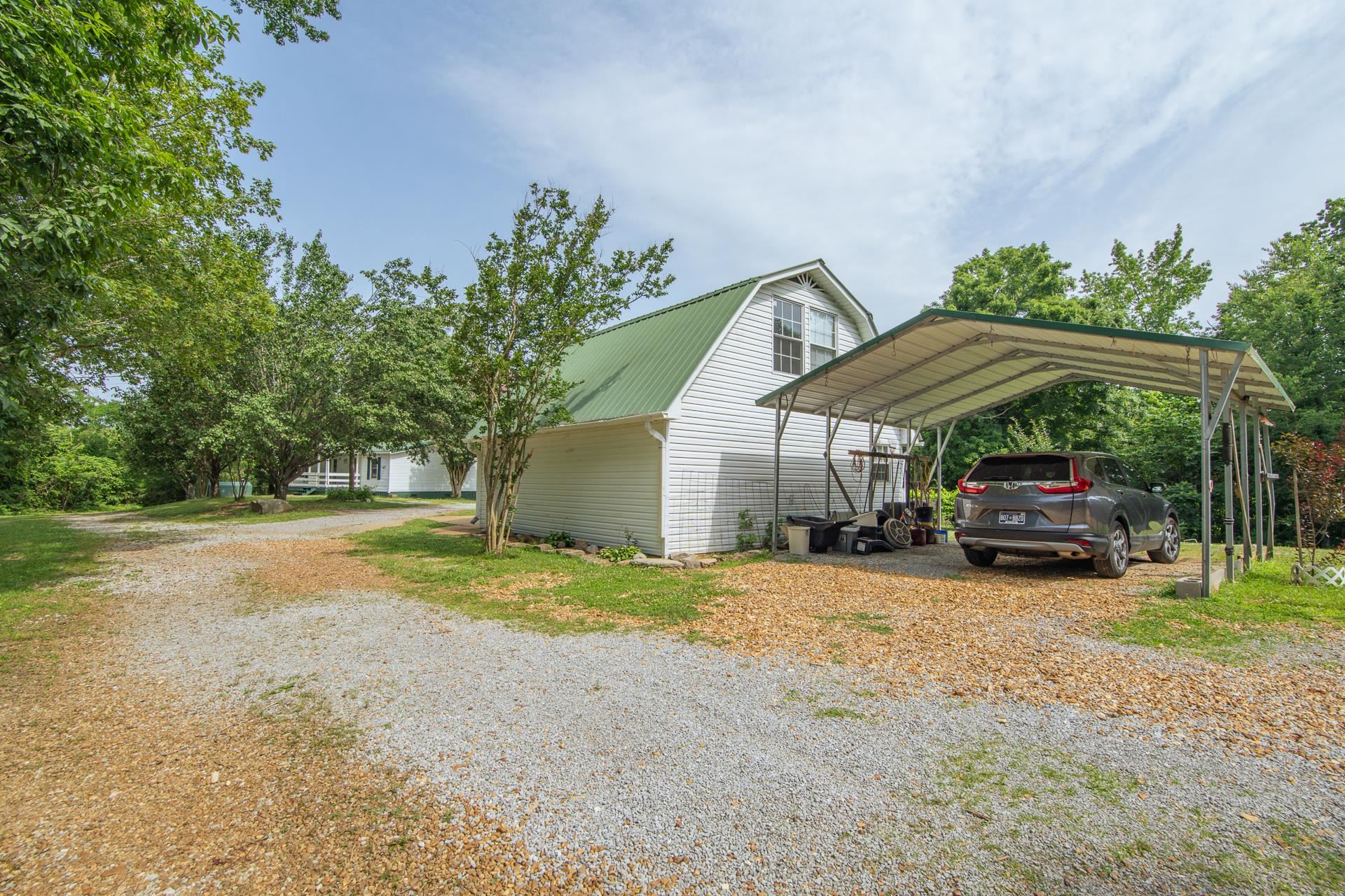 23 Old Ferry Road Bath Springs, TN 38311 - Photo 35 of 40 a view of a house with backyard and sitting area