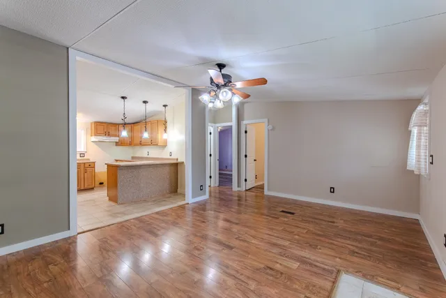 a view of a kitchen with a sink and a refrigerator
