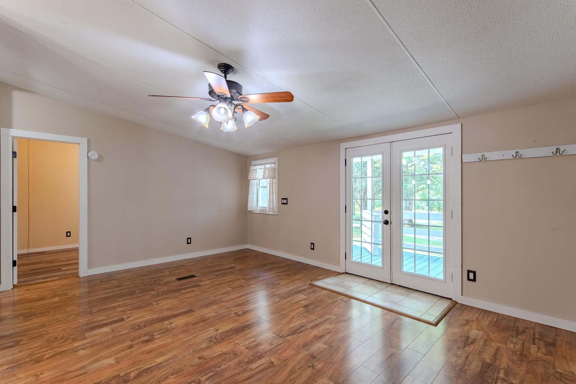 23 Old Ferry Road Bath Springs, TN 38311 - Photo 6 of 40 wooden floor in an empty room with a window