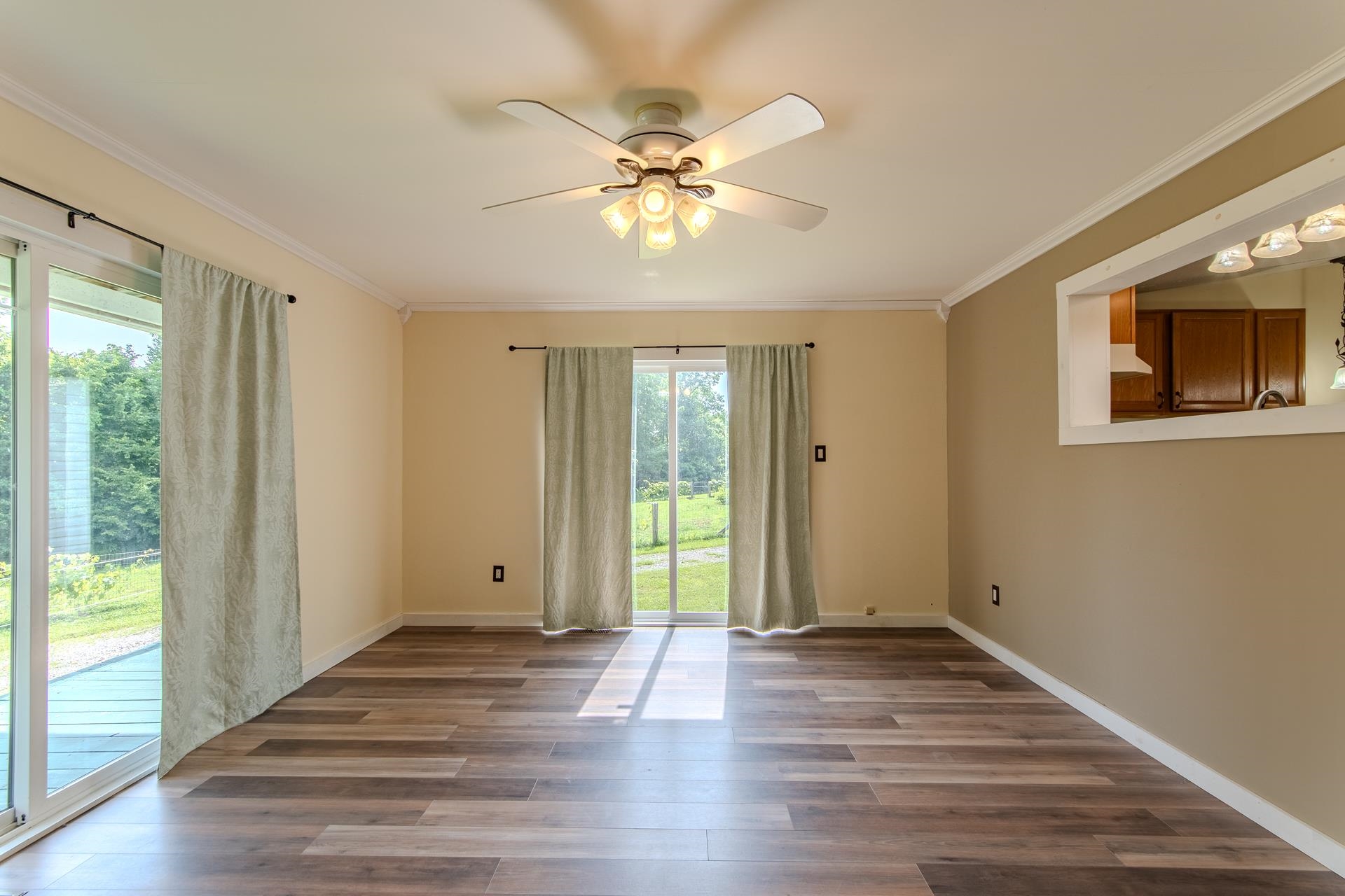 23 Old Ferry Road Bath Springs, TN 38311 - Photo 7 of 40 a view of an empty room with wooden floor and a window