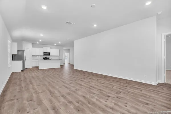 a kitchen with cabinets stainless steel appliances and a counter space