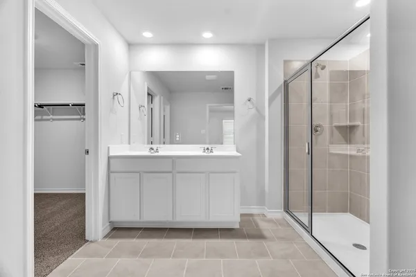 a bathroom with a shower sink and mirror