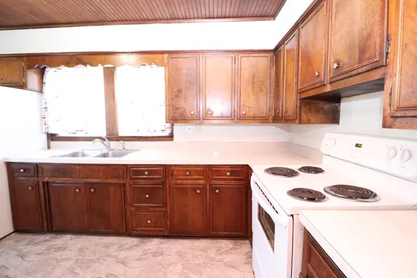 a kitchen with a sink a stove and a microwave