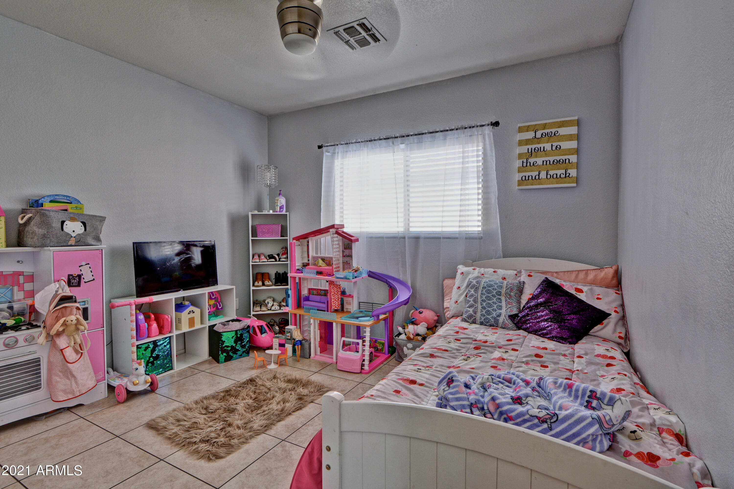 7945 West Hatcher Road Peoria, AZ 85345 - Photo 9 of 15 a bedroom with a bed and a tv