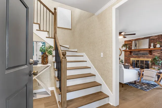 a living room with fireplace furniture and a floor to ceiling window