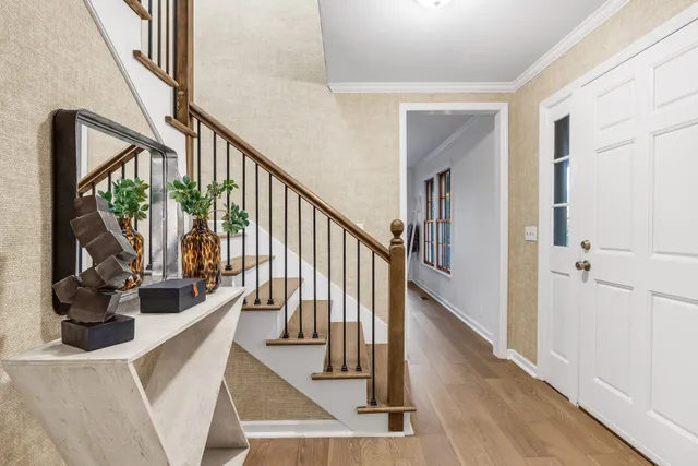 a kitchen with stainless steel appliances granite countertop a stove and white cabinets