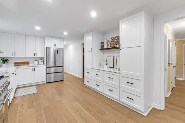 a living room with furniture a fireplace and a large window