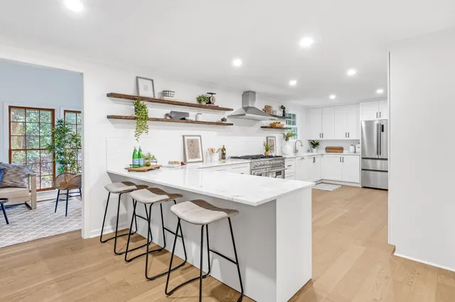 a living room with furniture a large window and table