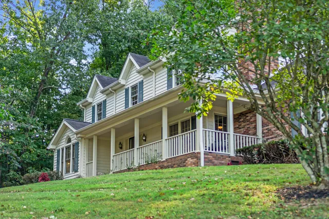 a view of a house with a yard and deck
