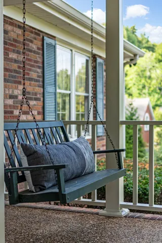 a living room with furniture a fireplace and a large window