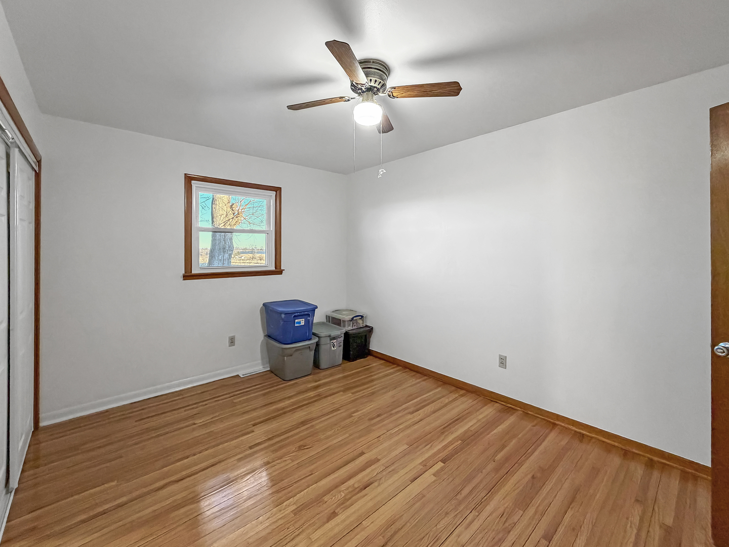 1165 North Henderson Road Freeport, IL 61032 - Photo 13 of 26 a view of a room with wooden floor and a ceiling fan