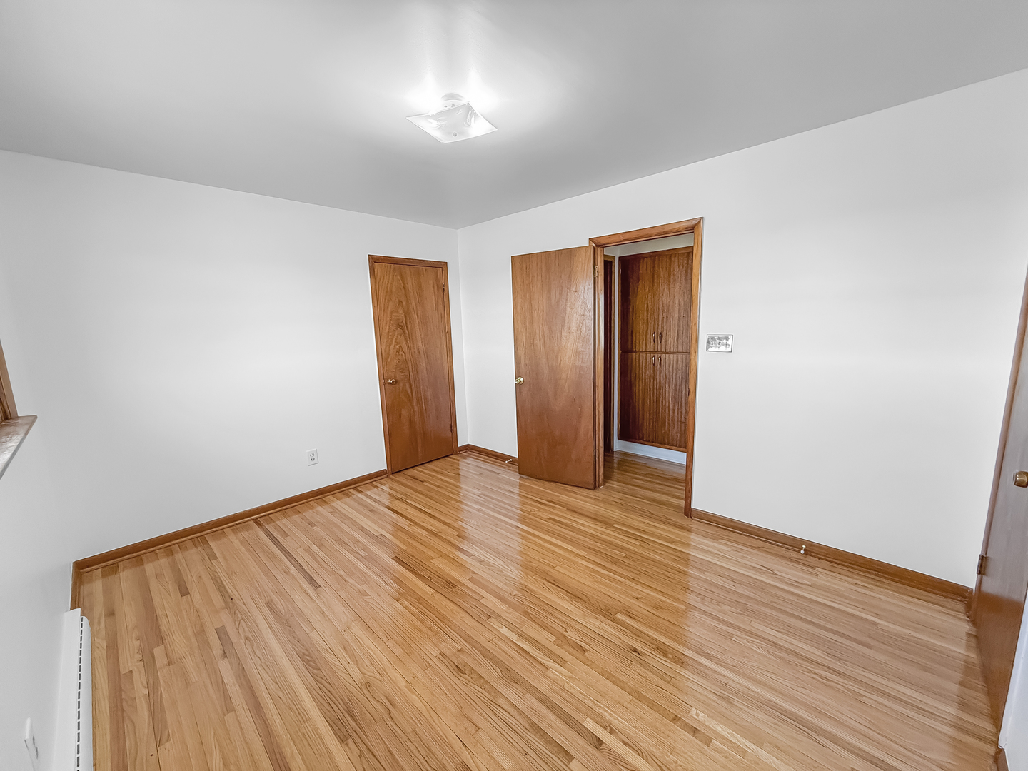 1165 North Henderson Road Freeport, IL 61032 - Photo 14 of 26 an empty room with wooden floor and closet