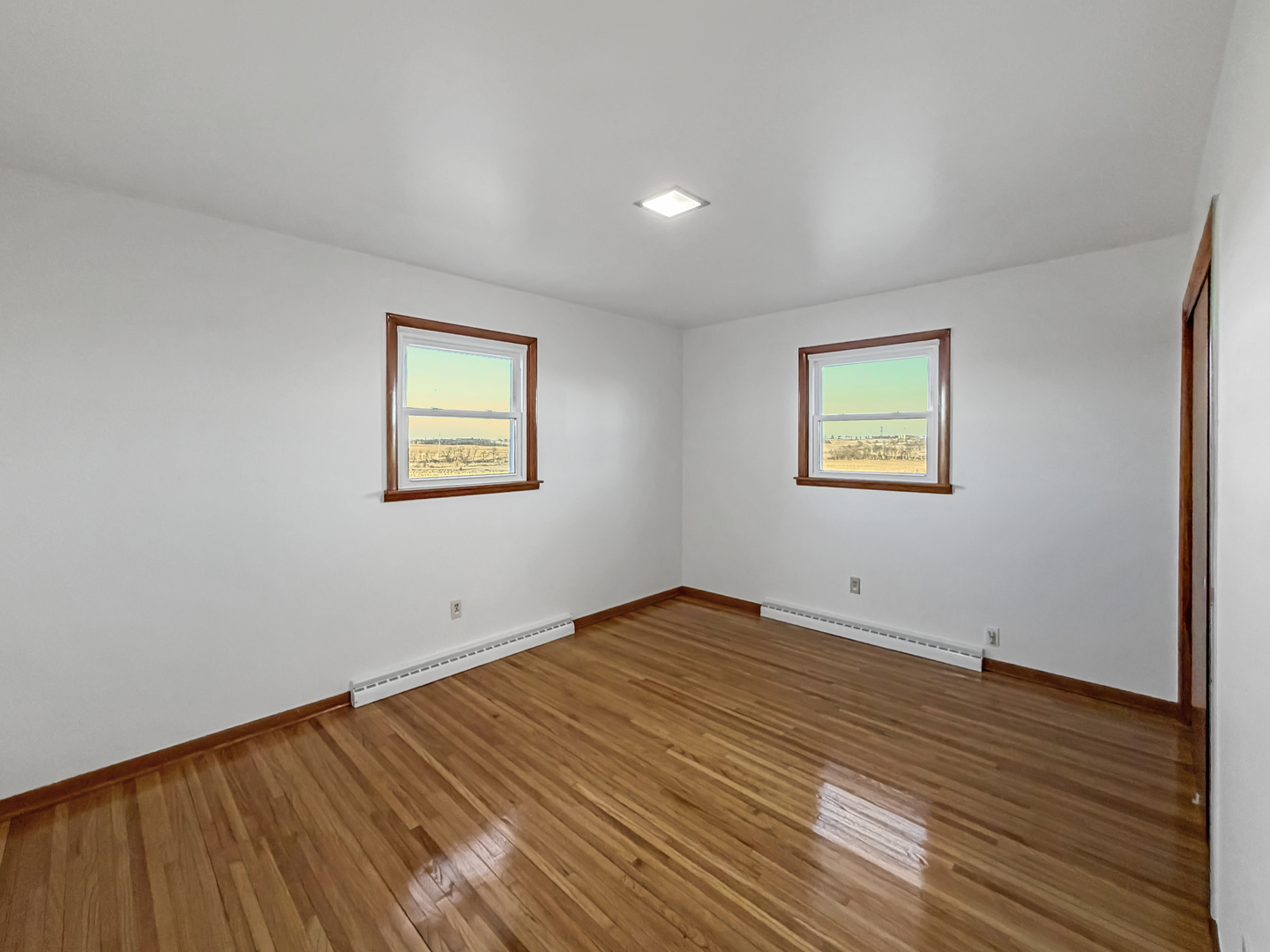 1165 North Henderson Road Freeport, IL 61032 - Photo 15 of 26 a view of an empty room with wooden floor and a window