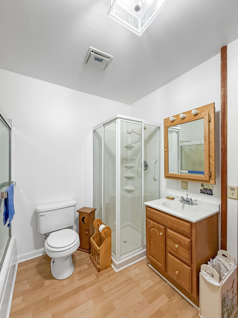 1165 North Henderson Road Freeport, IL 61032 - Photo 19 of 26 a bathroom with a toilet sink and mirror
