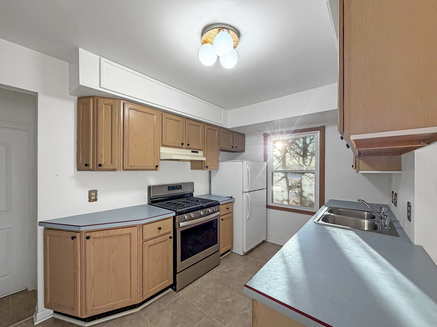 1165 North Henderson Road Freeport, IL 61032 - Photo 4 of 26 a kitchen with stainless steel appliances granite countertop a sink stove and cabinets