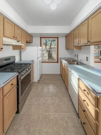 a kitchen with stainless steel appliances granite countertop a stove a sink dishwasher and a refrigerator