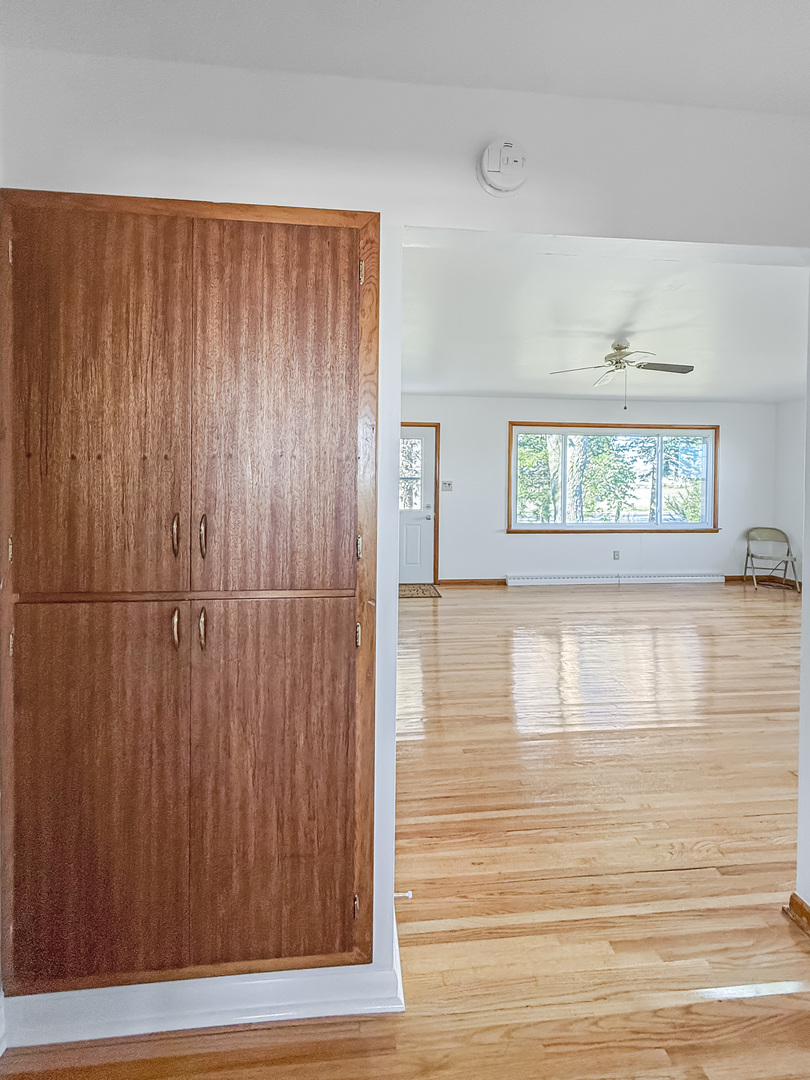 1165 North Henderson Road Freeport, IL 61032 - Photo 10 of 26 a view of an empty room with wooden floor and a window