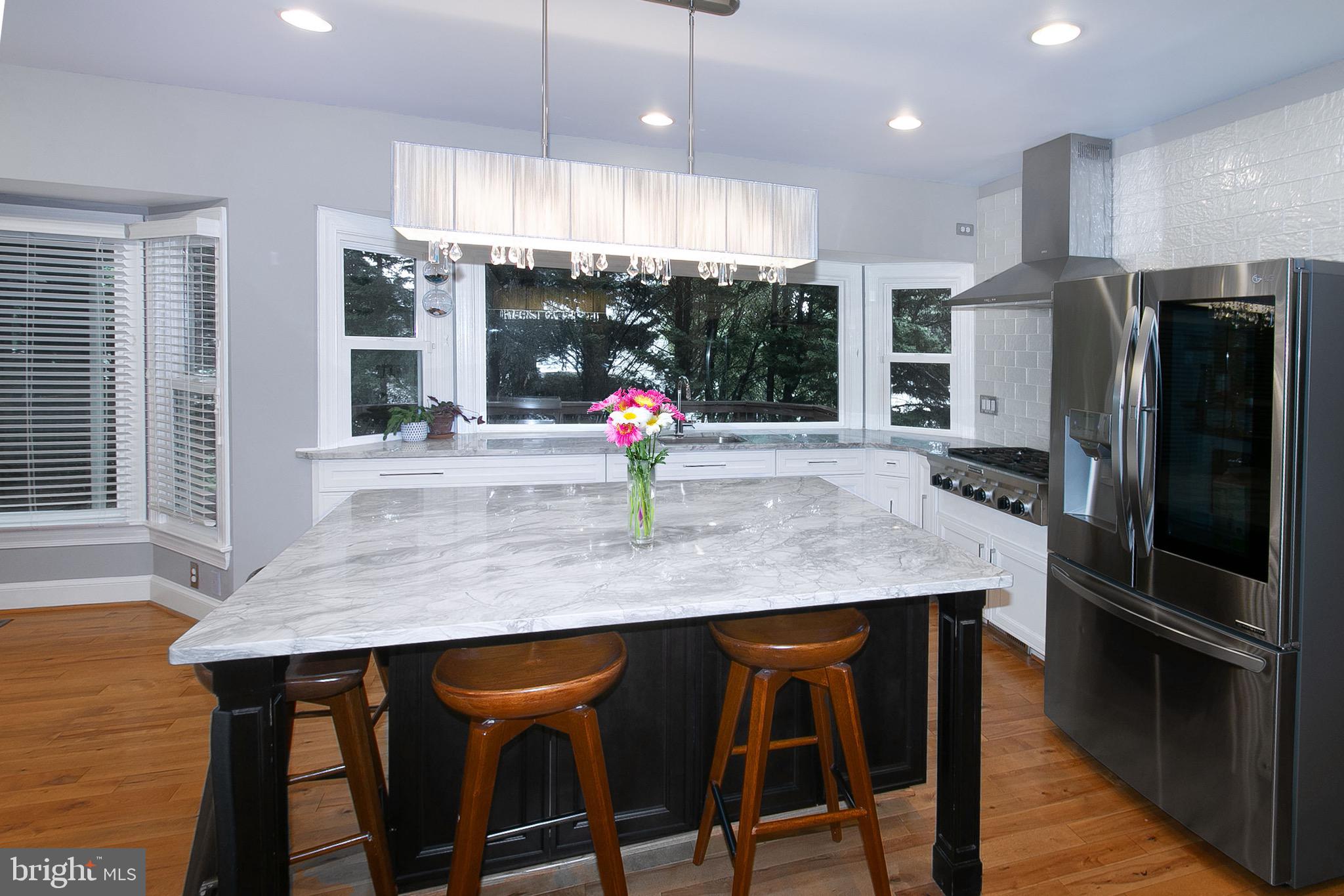 13500 Over Ridge Court Chantilly, VA 20151 - Photo 11 of 41 a kitchen with stainless steel appliances granite countertop a table chairs refrigerator and microwave