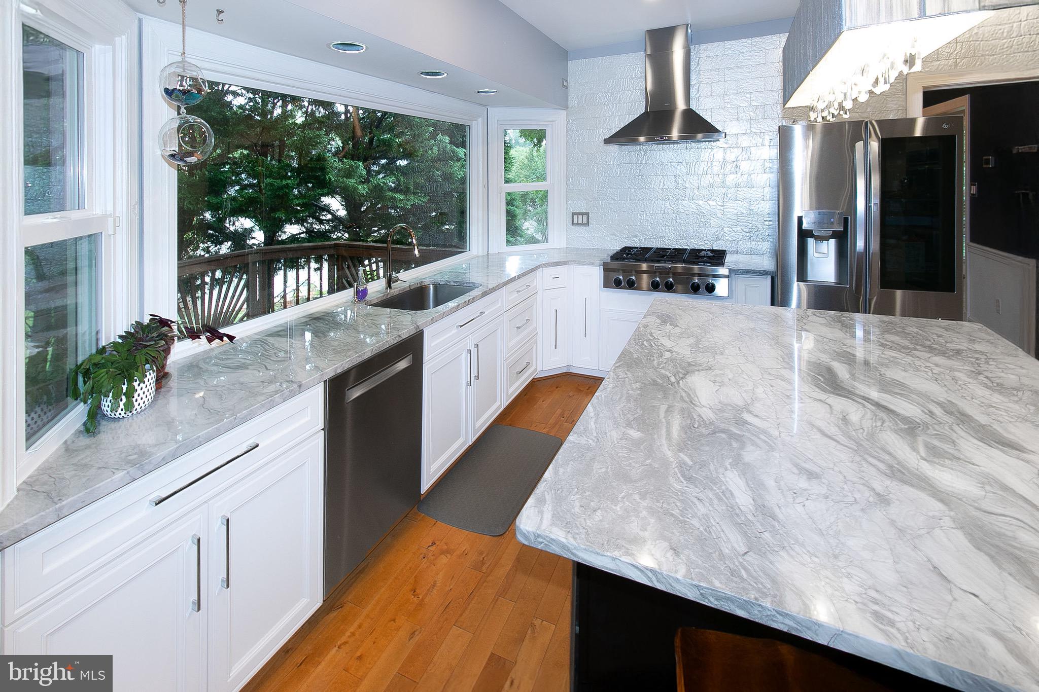 13500 Over Ridge Court Chantilly, VA 20151 - Photo 12 of 41 a large kitchen with kitchen island a large counter space a sink a window and stainless steel appliances