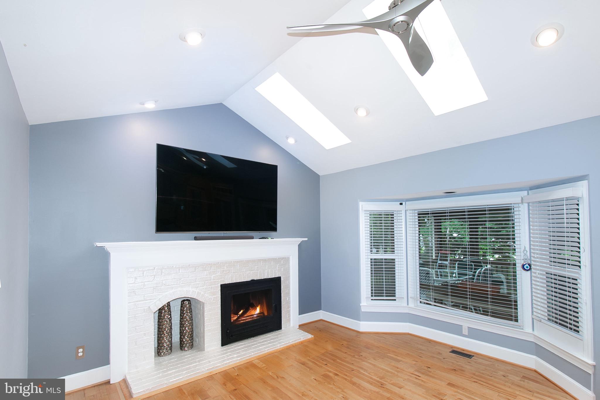 13500 Over Ridge Court Chantilly, VA 20151 - Photo 15 of 41 a living room with a fireplace and a flat screen tv