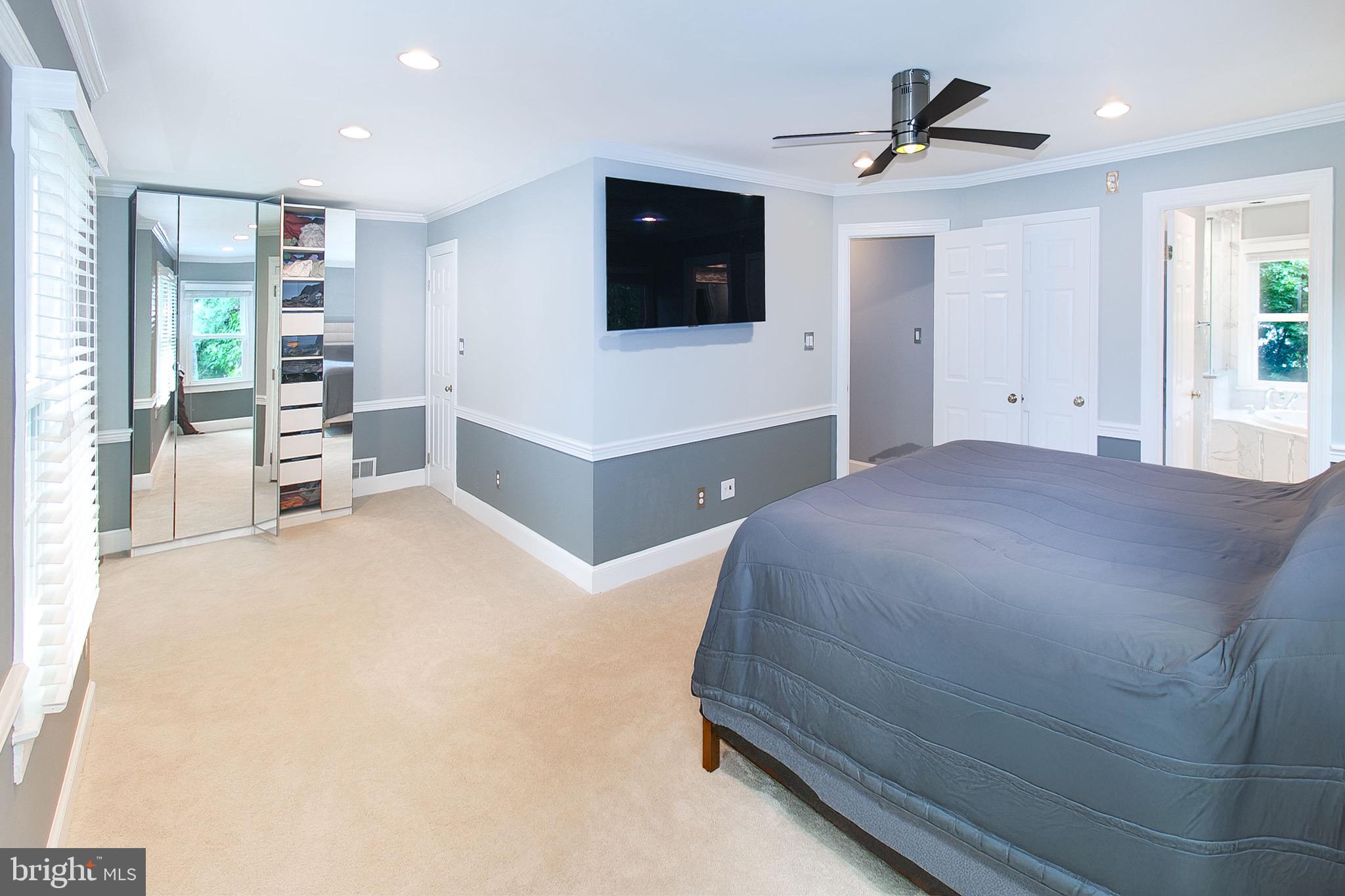13500 Over Ridge Court Chantilly, VA 20151 - Photo 19 of 41 a spacious bedroom with a bed and a flat screen tv