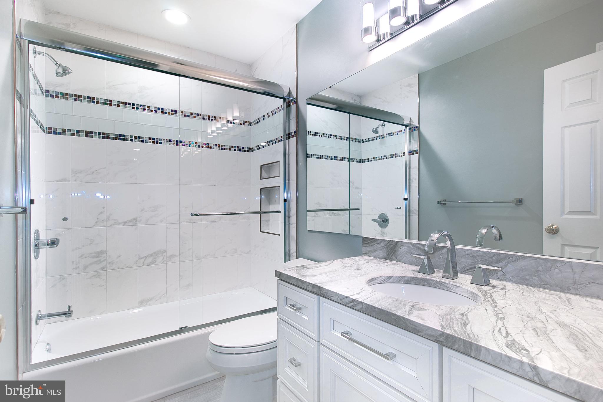 13500 Over Ridge Court Chantilly, VA 20151 - Photo 29 of 41 a bathroom with a granite countertop sink mirror toilet and bathtub