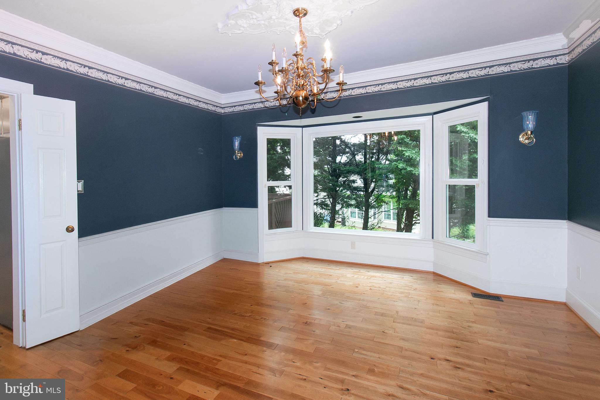 13500 Over Ridge Court Chantilly, VA 20151 - Photo 10 of 41 a view of an empty room with wooden floor and a chandelier