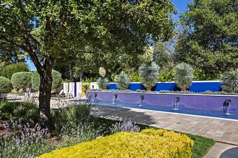 a view of a backyard with swimming pool