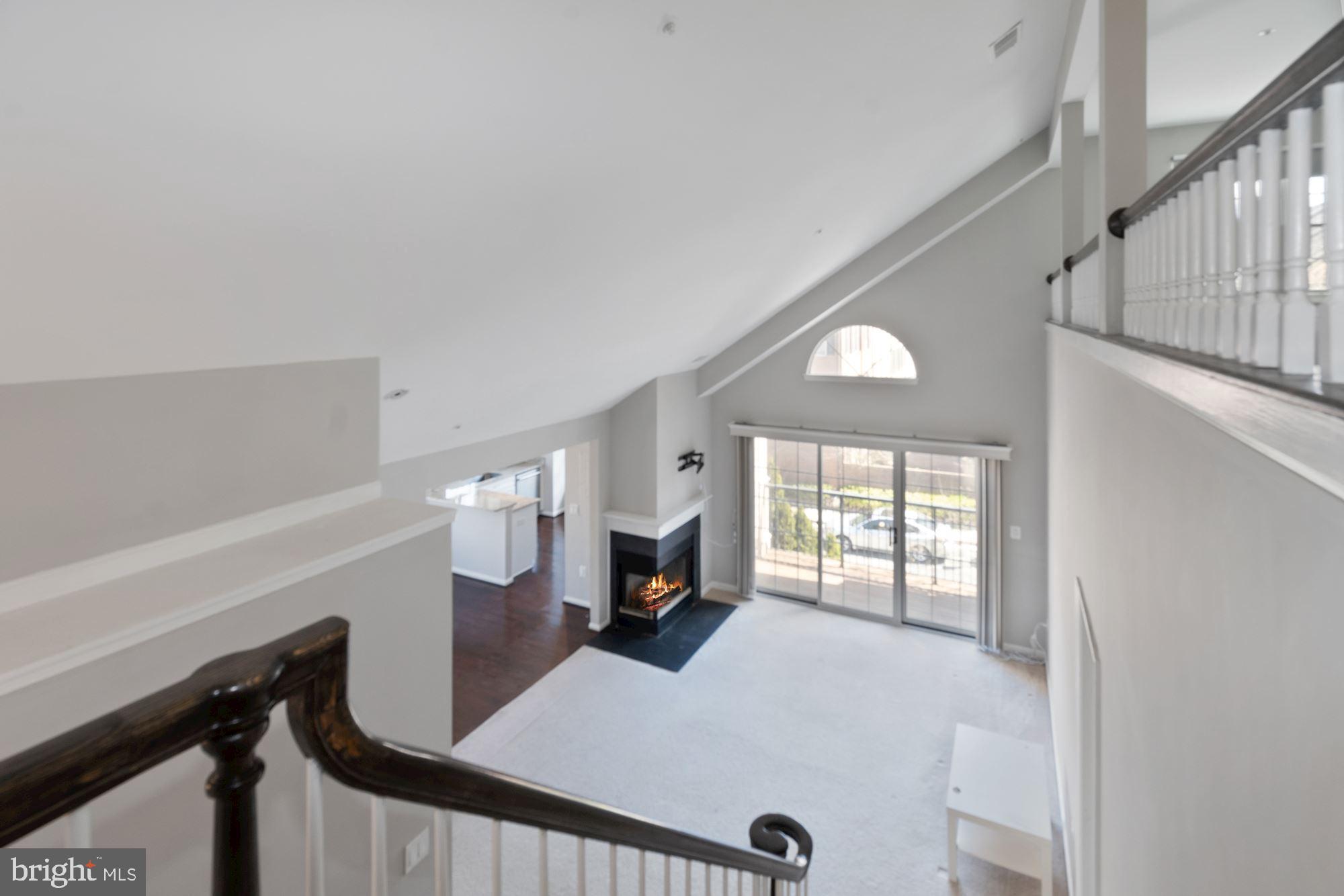 304 Ridgepoint Place, Unit 32 Gaithersburg, MD 20878 - Photo 20 of 28 a living room with furniture and a fireplace