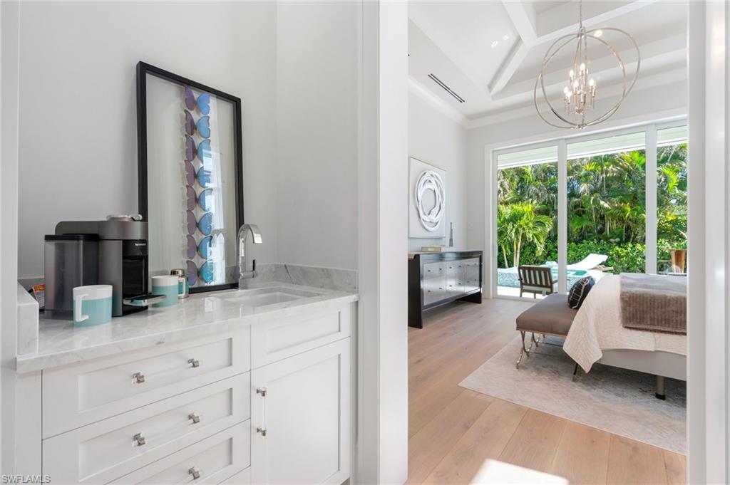 3290 Crayton Road Naples, FL 34103 - Photo 18 of 50 a living room with furniture and a large window