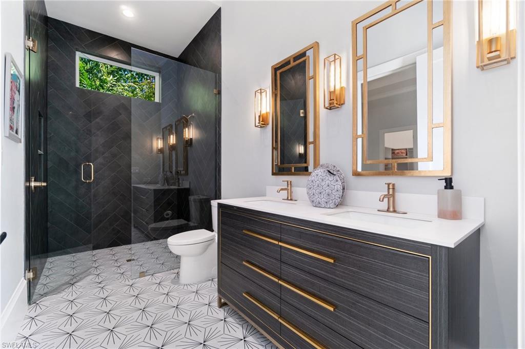 3290 Crayton Road Naples, FL 34103 - Photo 29 of 50 a bathroom with a sink a toilet and shower
