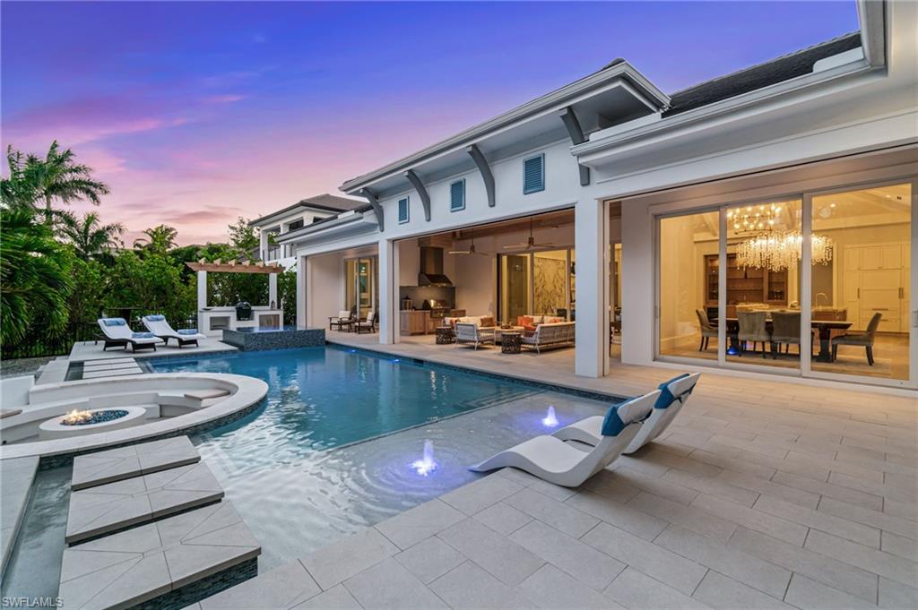 3290 Crayton Road Naples, FL 34103 - Photo 37 of 50 a view of a patio with swimming pool table and chairs
