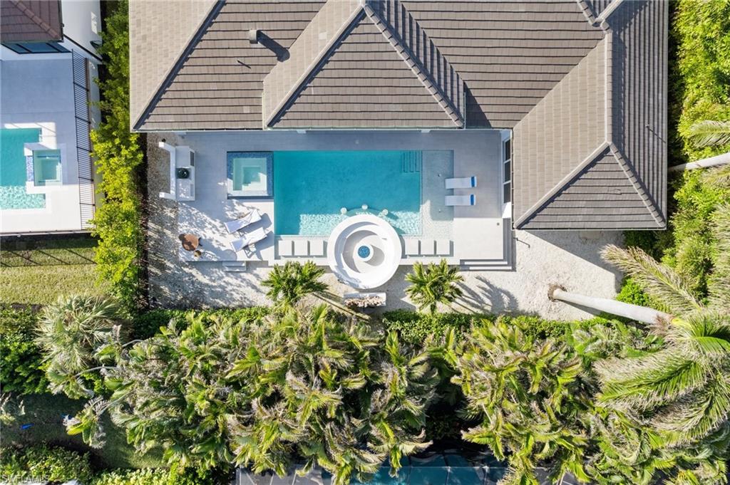 3290 Crayton Road Naples, FL 34103 - Photo 48 of 50 a front view of a house with garden
