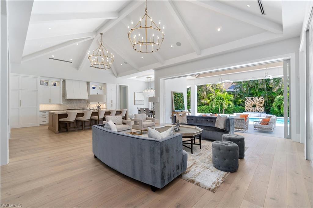 3290 Crayton Road Naples, FL 34103 - Photo 8 of 50 a living room with furniture and a chandelier
