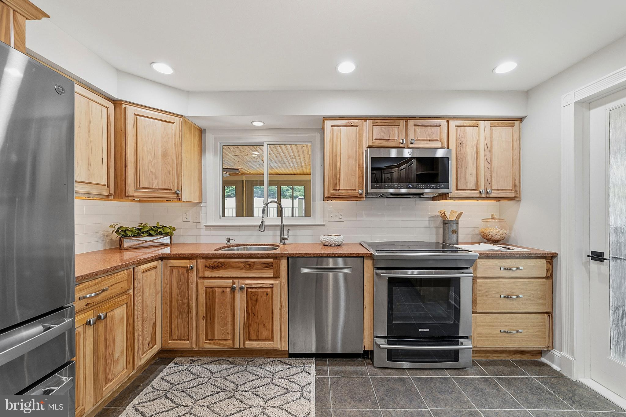 117 Harvest Road Cherry Hill, NJ 08002 - Photo 20 of 35 a kitchen with stainless steel appliances granite countertop a stove top oven a sink dishwasher and a refrigerator
