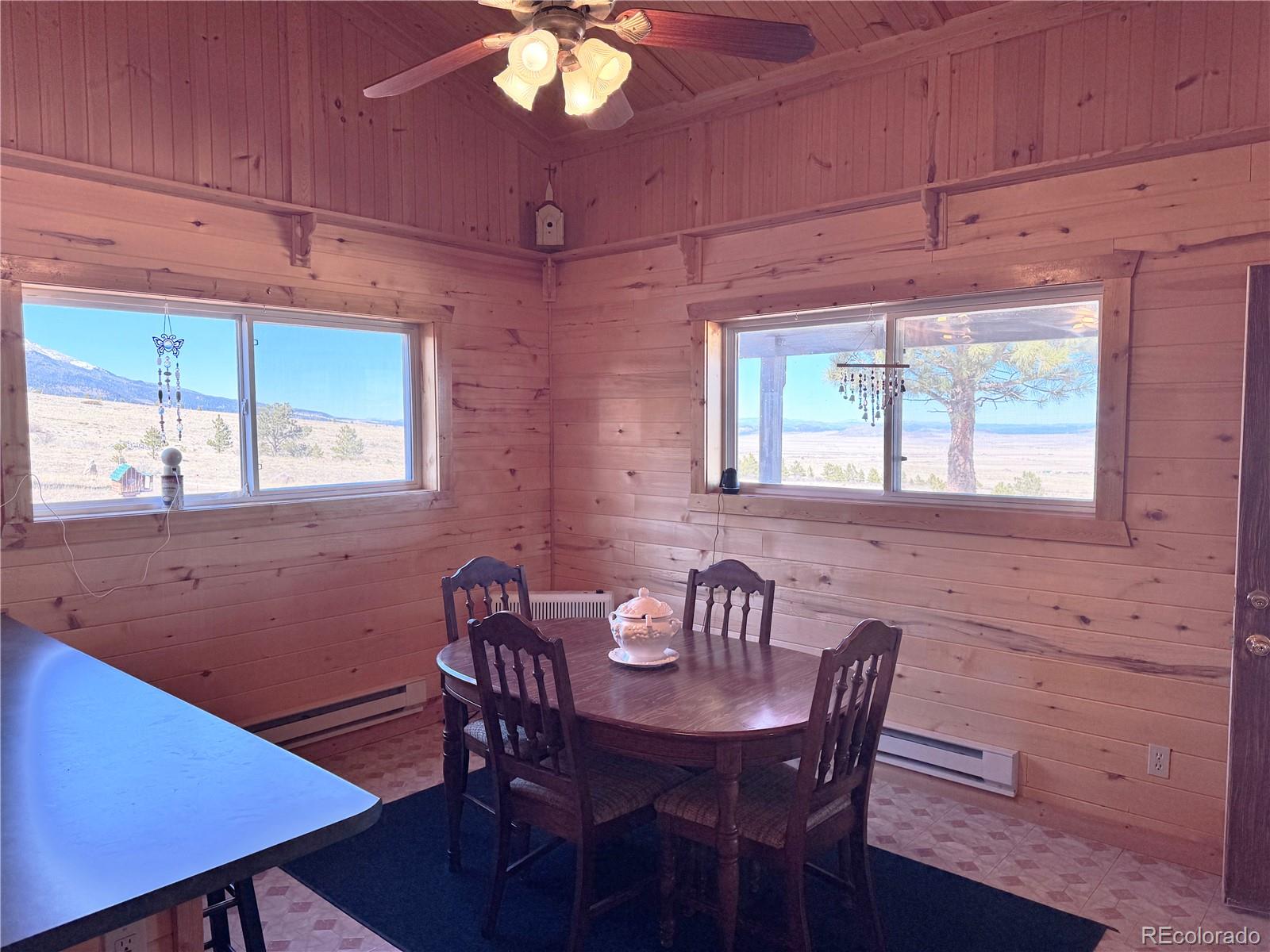 62 Rubel Road Westcliffe, CO 81252 - Photo 29 of 38 a view of a dining room with furniture window and wooden floor