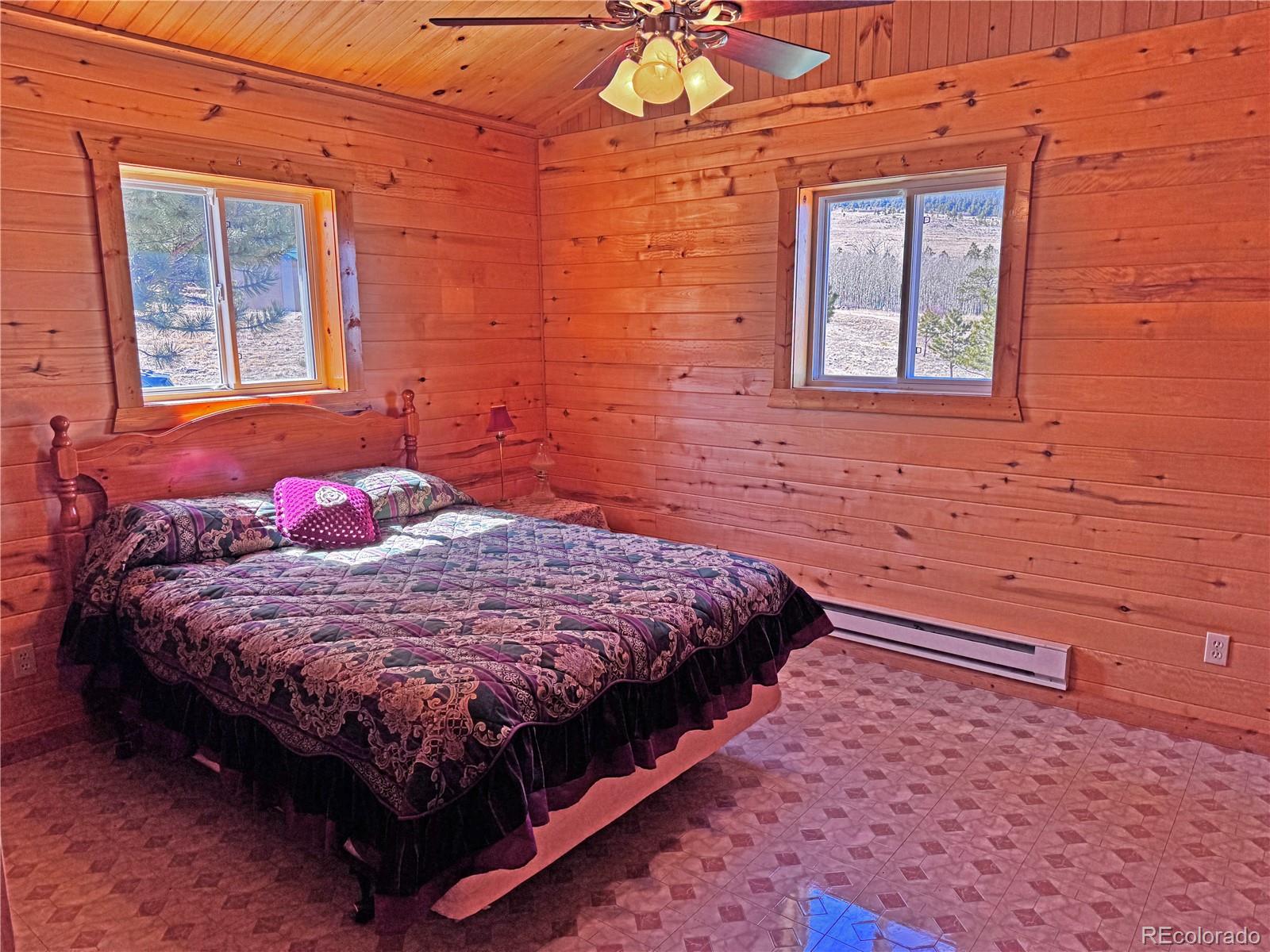 62 Rubel Road Westcliffe, CO 81252 - Photo 36 of 38 a bed sitting in a bedroom next to a window