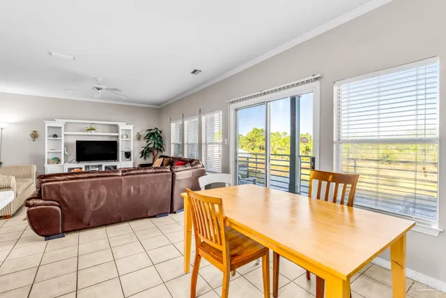 a living room with furniture a flat screen tv and a large window