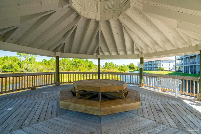 a balcony with furniture and wooden floor