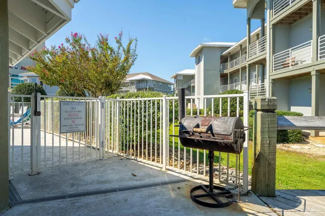 a view of a deck with a floor to ceiling window next to a yard