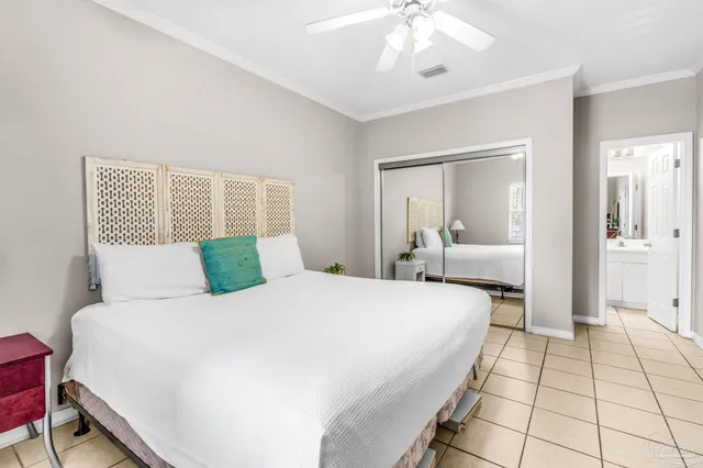 a bedroom with a bed and a mirror