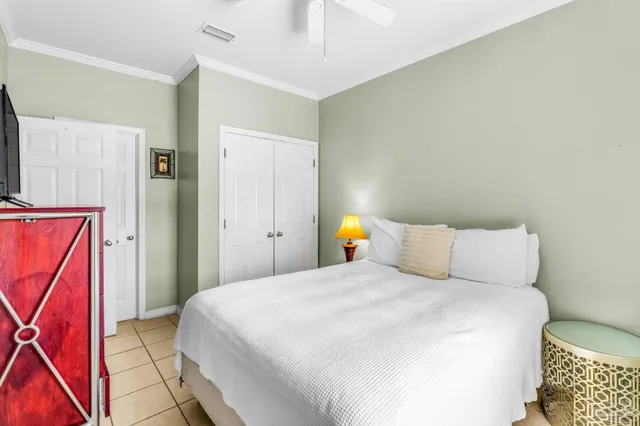 a bedroom with a bed and a television