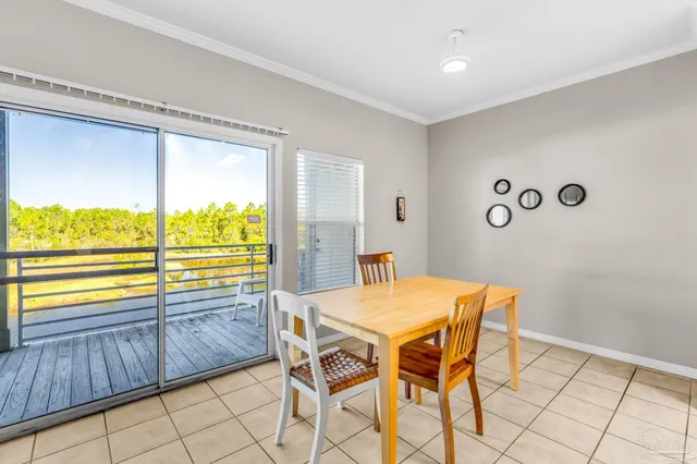 a view of a dining room with furniture and a large window