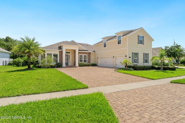a front view of a house with a yard and garage